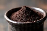 Dark black cocoa powder in glass jar